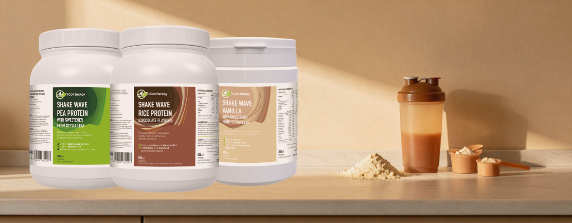 three protein powder bottles on thekitchen desk next to protein shaker